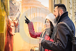 Modern hipster couple shopping on winter cloth pointing moda sto photo