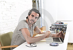 Modern hipster style student or businessman working in stress with laptop at home office angry upset