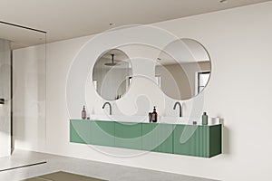 Modern home bathroom interior with double sink and accessories, glass shower