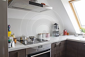 Modern home kitchen desk with pots and kitchen appliances