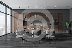 Modern home kitchen interior with eating table and seats, panoramic window