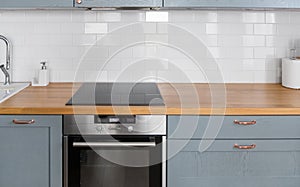 Modern home kitchen interior with oven and hob