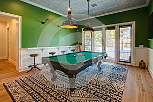 Modern home pool game room with table