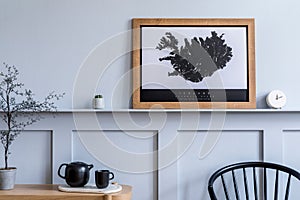 Modern home staging of living room with design chair, wooden console, mock up poster map.