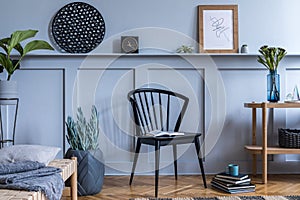 Modern home staging of living room with design chair, wooden console, mock up poster map.