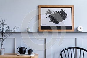 Modern home staging of living room with design chair, wooden console, mock up poster map. photo