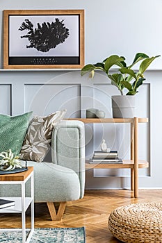 Modern home staging of living room with design mint sofa, wooden console, coffee table, rattan pouf, carpet, pillows, plant.
