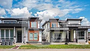 Modern homes. Real estate exterior of a new modern houses. Front view of modern designed concrete residential house