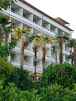 Modern hotel with balconies overlooking the beautiful greenery park in the south