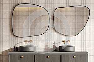 Modern hotel bathroom interior with double sink and accessories on vanity