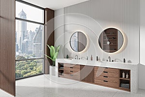 Modern hotel bathroom interior with double sink and vanity, panoramic window