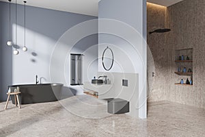 Modern hotel bathroom interior with washbasin, bathtub, shower and toilet