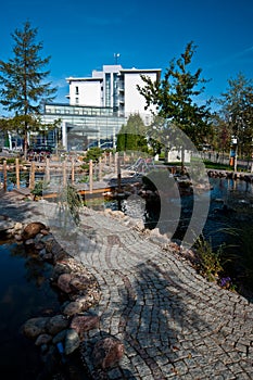 Modern hotel exterior with pond