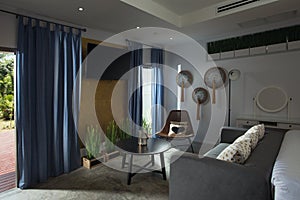 Modern hotel room with coffee table and chair