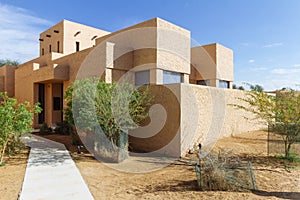 Modern hotel villa on desert with decorated building skin like sand color at Abu Dhabi, UAE