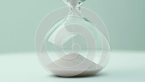 Modern hourglass with gray background for copy space. Concept for business deadline, urgency and running out of time.