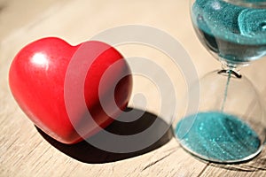 Modern hourglass and red heart with copy space.