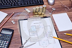 Modern house with computer keyboard, calculator, notepad, pen, coin and pencil