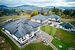 Modern house cottage in the mountains with solar photovoltaic panel system on roof.