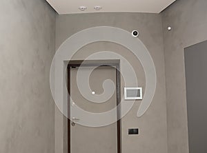 Modern house entrance metal door interior with smart house system, security camera, smoke alarms and fire detection