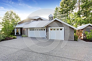 Modern house exterior with curb appeal. View of garage and spacious driveway