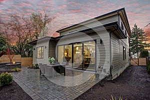 Modern house exterior with a deck at sunset.