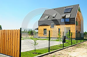 Modern House Exterior. Solar panel and solar water heater on the modern house roof with skylights photo