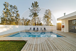 Modern house garden swimming pool and wooden deck