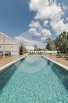 Modern house with garden swimming pool and wooden deck