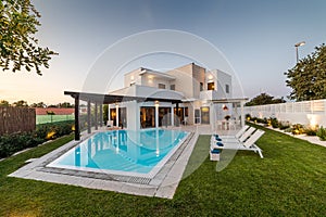 Modern house with garden swimming pool and wooden pergula