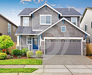 Modern house with gray exterior, and blue white trim.