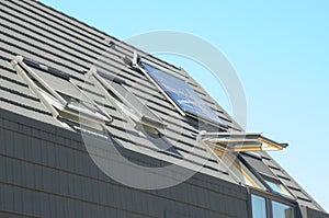 Modern House Roof with Solar Water Heater, Solar Panels and Skylights. Attic House with Solar Panels, Skylights and Dormer.