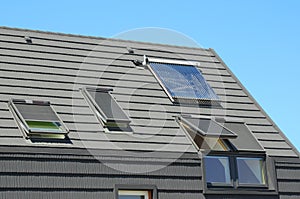 Modern House Roof with Solar Water Heater, Solar Panels and Skylights, Beautiful New Contemporary House with Solar Panels. photo