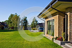 Modern house side yard with large garden window