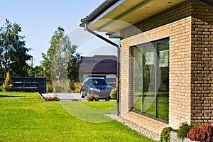 Modern house side yard with large garden window