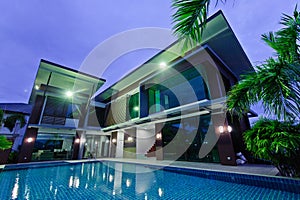 Modern house with swimming pool at night