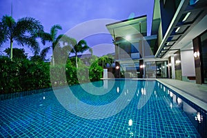 Modern house with swimming pool at night