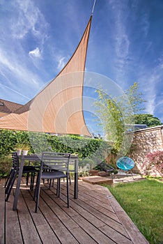 Modern house terrace in summer with shade sail