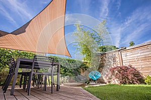 Modern house terrace in summer with shade sail photo