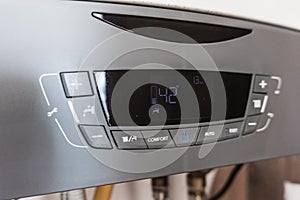 Modern house water heater control panel. The fall of the cold weather and the rise in consumer prices