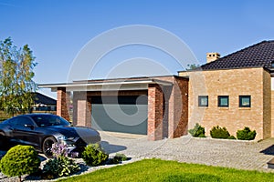 Modern house yard with garage and expensive car