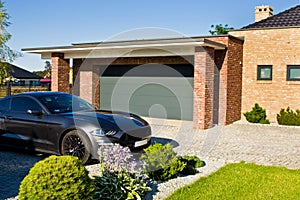 Modern house yard with garage and expensive car