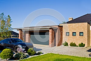 Modern house yard with garage and expensive car photo