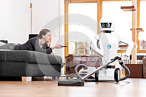 A modern household robot is vacuuming the floor