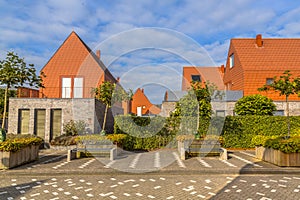 Modern houses with conspicious red slate roof tiles