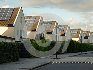Modern houses in a row with solar panels on the roof in largest photovoltaic neighbourhood of The Netherlands in Heerhugowaard