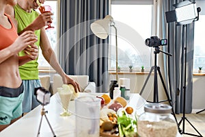 Modern Ideas. Cropped shot of sportive couple recording video blog or vlog about healthy nutrition on camera at home