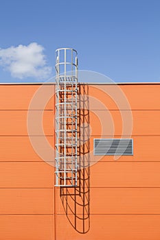 Modern industrial building wall with metal ladder