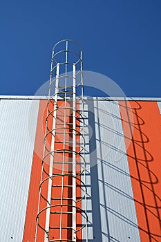 Modern industrial building wall with metal ladder, stairs