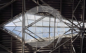 modern industrial glass window shaped in the ceiling with beams